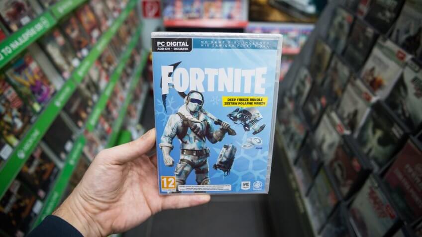 Bratislava, Slovakia, march 8, 2019: Man holding popular videogame Fortnite on PC in store.