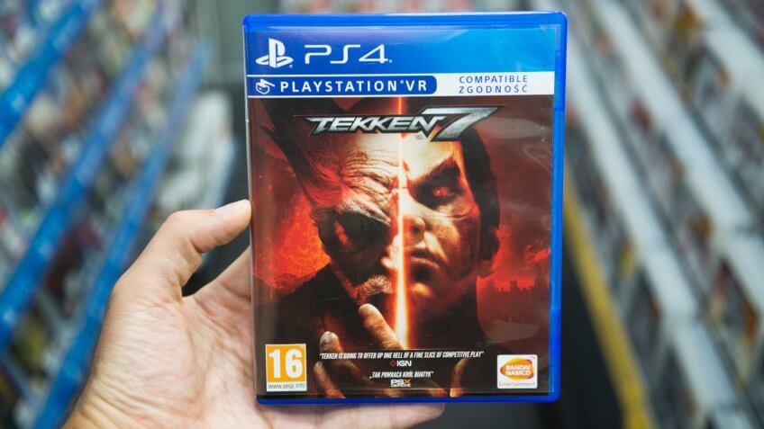 Bratislava, Slovakia, June 1, 2017: Man holding Tekken 7 videogame on Sony Playstation 4 console in store.
