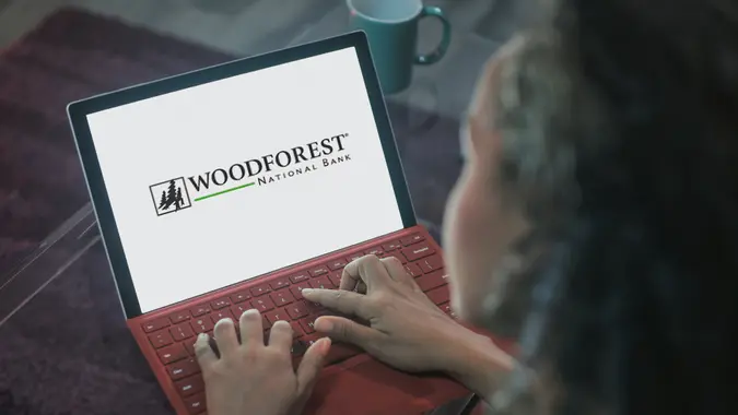 Young black woman typing on laptop computer at night.