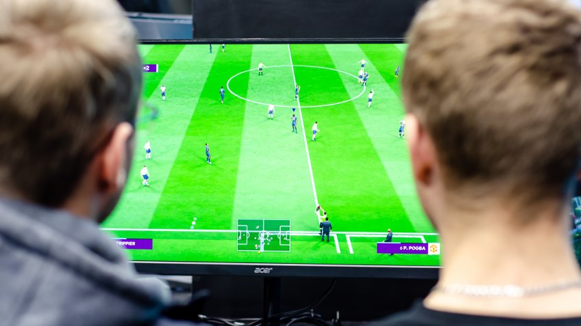 Kyiv, Ukraine - April 12, 2019: The guys are playing a football video game.
