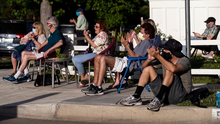 ATTENTION: This Image is part of a PHOTO SETMandatory Credit: Photo by ETIENNE LAURENT/EPA-EFE/Shutterstock (10649279o)Neighbors react as musician Adam Chester performs during his weekly neighborhood concert called 'Quaranchella' amid the coronavirus disease (COVID-19) pandemic in Sherman Oaks, North-West of Los Angeles, California, 16 May 2020.