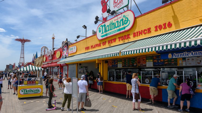 Mandatory Credit: Photo by Erik Pendzich/Shutterstock (10649320j)People observe social distancing as the stand in line at Nathan's Famous Hot Dogs on the Coney Island boardwalk during the COVID-19 outbreak.