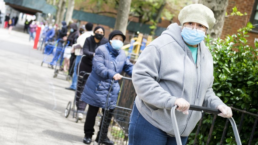 Mandatory Credit: Photo by JUSTIN LANE/EPA-EFE/Shutterstock (10650905g)A long line of people wait to pick up donated food being distributed to those in need at the General Grant Houses in New York, New York, USA, 18 May 2020.