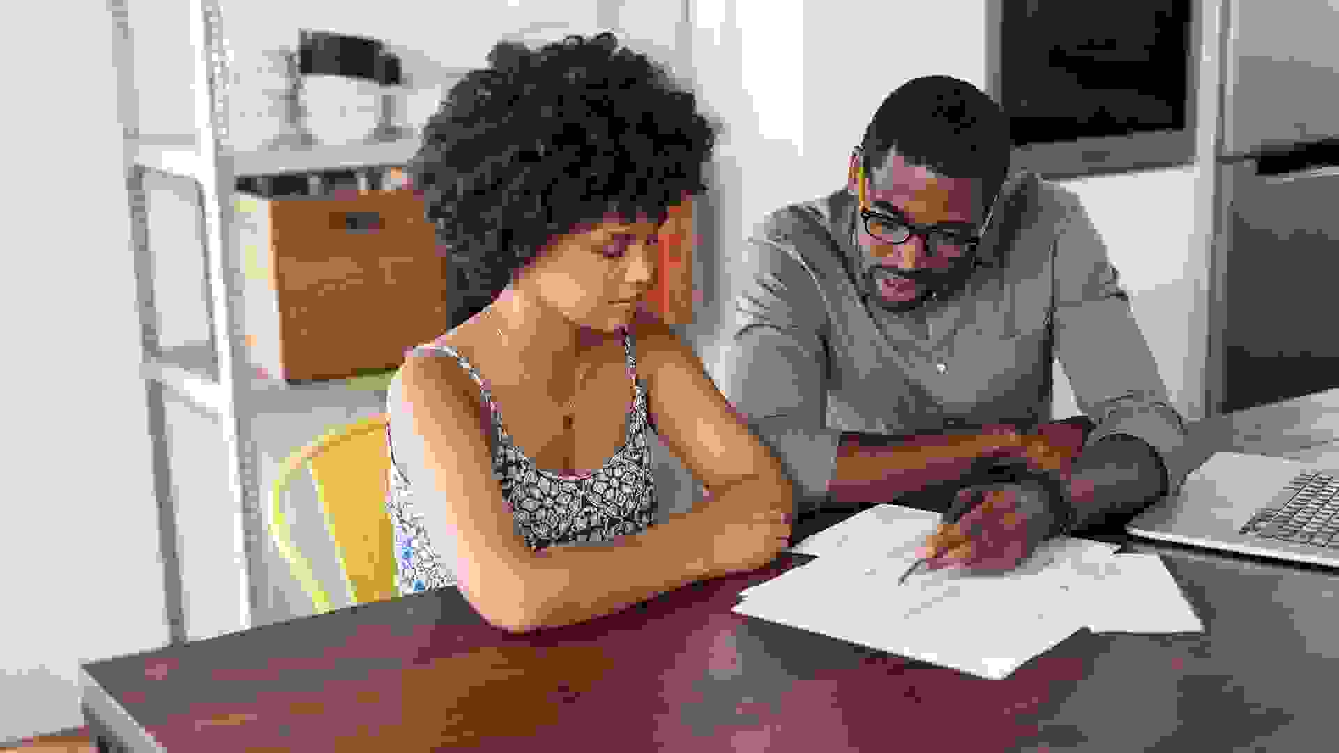 Shot of a young couple going through paperwork at home.