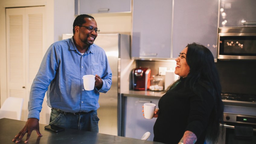 Colleagues staying after work for a drink in the co-working space cantina - kitchen.