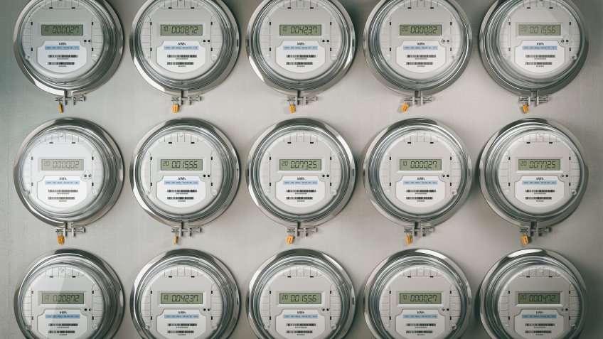 Digital electric meters in a row dad power use. Electricity consumption concept.