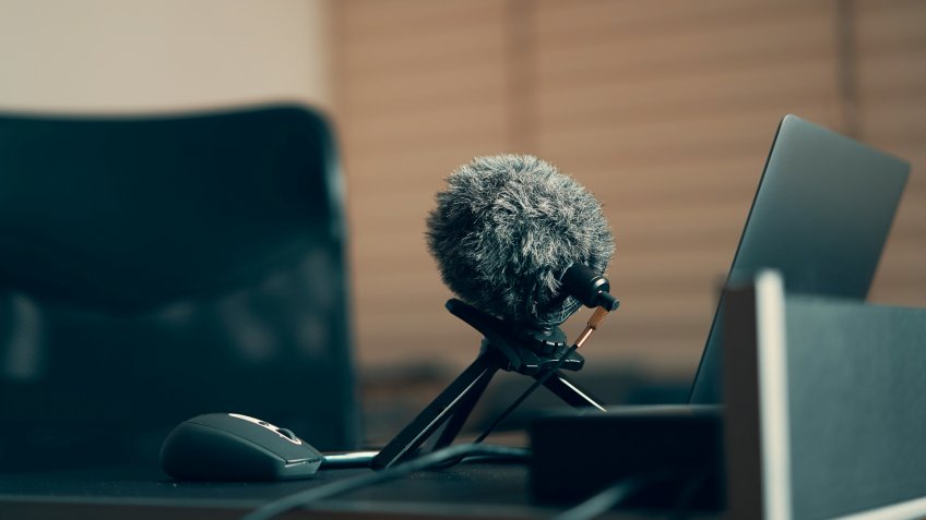 Laptop , microphone on a desk , e-learning area and equipments.