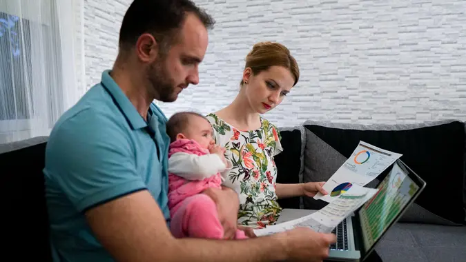 Business couple investing online from home.