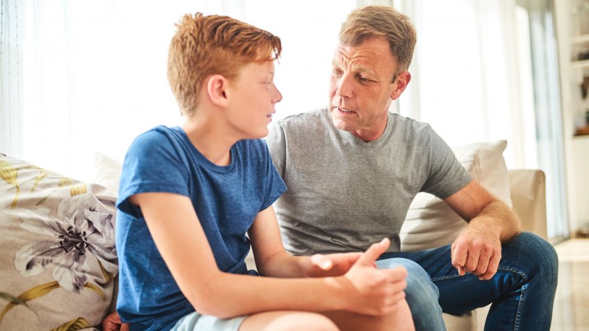 Shot of a mature father and his son having a disagreement at home.