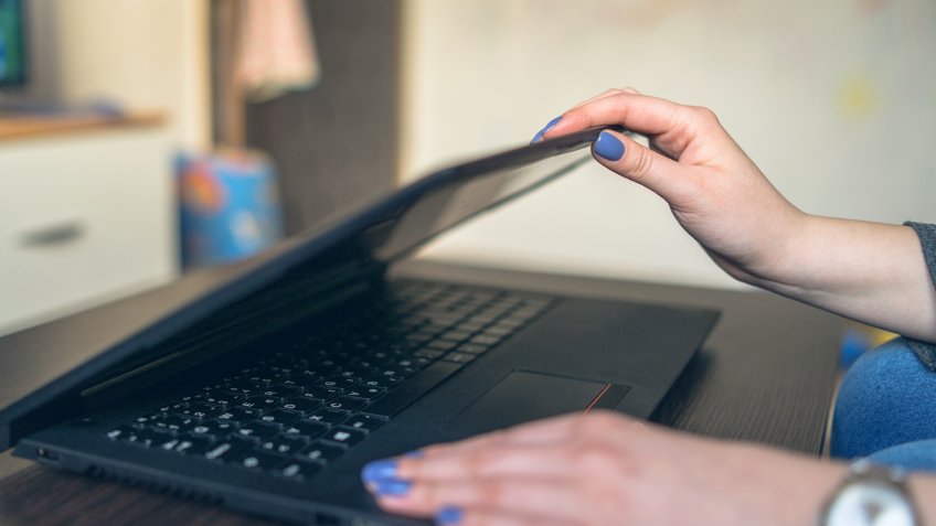 Close up on Female Hands opening the Laptop at Home.