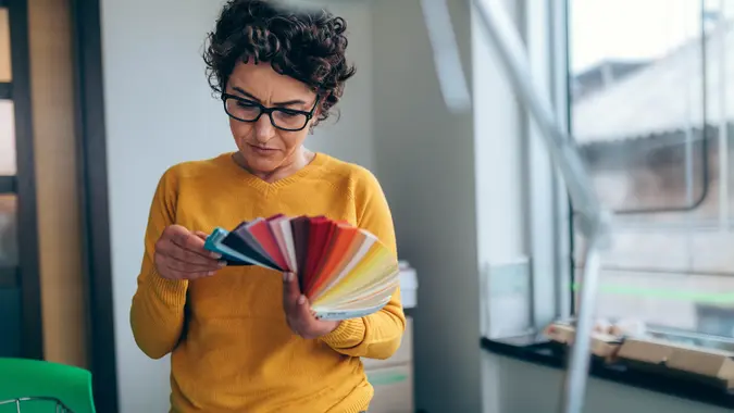 Photo of designer working with palette closeup in office.