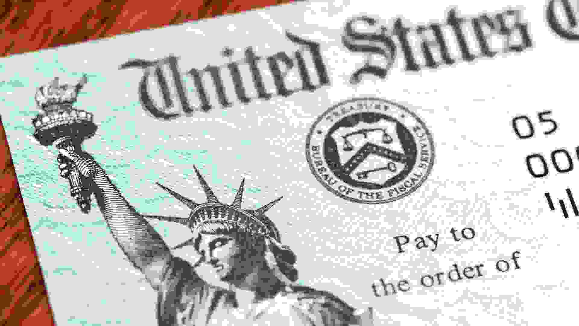 Partial view of a USA Treasury Internal Revenue Service tax refund check showing the Treasury seal and image of the Statue of Liberty.