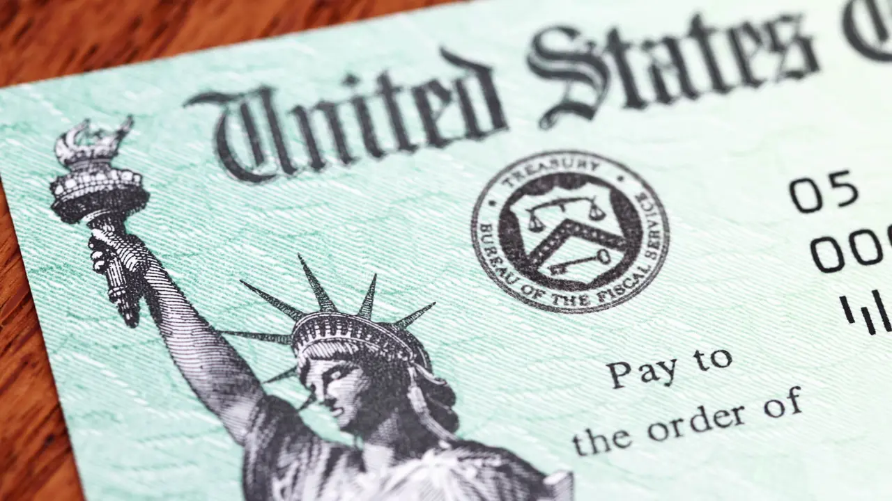 Partial view of a US Treasury Internal Revenue Service tax refund check showing the Treasury seal and image of the Statue of Liberty.