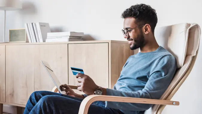 Internet shopper entering credit card information using digital tablet.