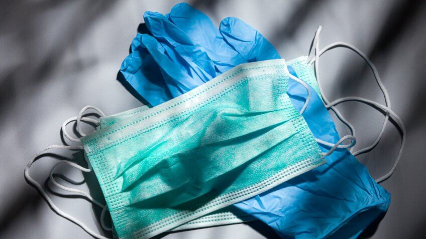Disposable mask against Coronavirus 2019-nCoV droplet infection and an antibiotic syringe.