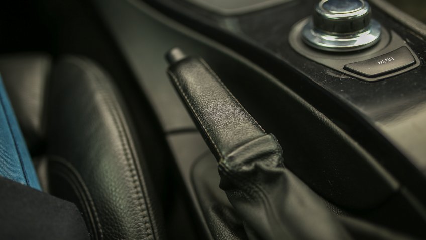handbrake lever in a car with leather upholstery.