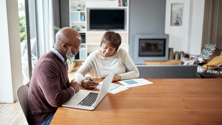 Cropped shot of a senior couple sitting together and going over their financial documents together in their home.