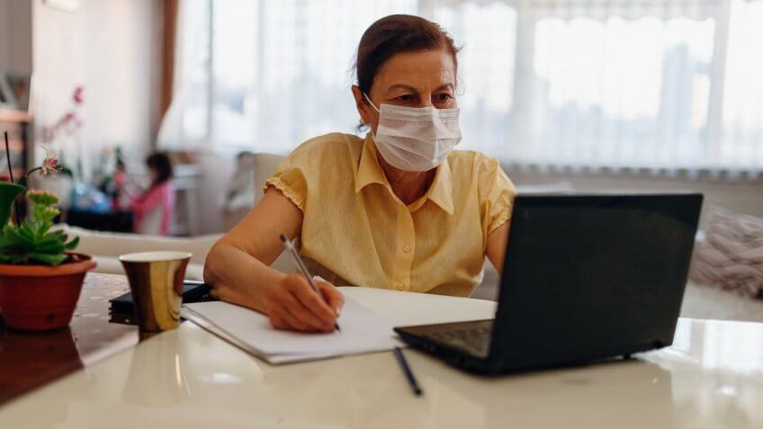 senior woman working on laptop at home.