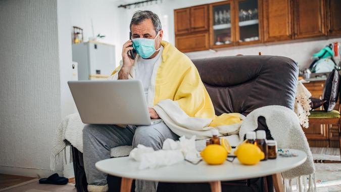 sick man of virus uses mobile phone.