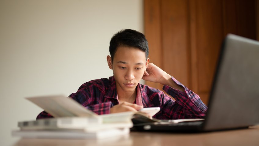 Teenage boy study hard to prepare for an exam at school.