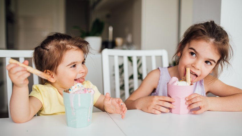 Girls eating sweet food at home.
