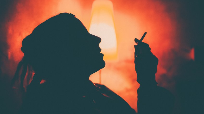 woman smoking a cigarette ruining her life
