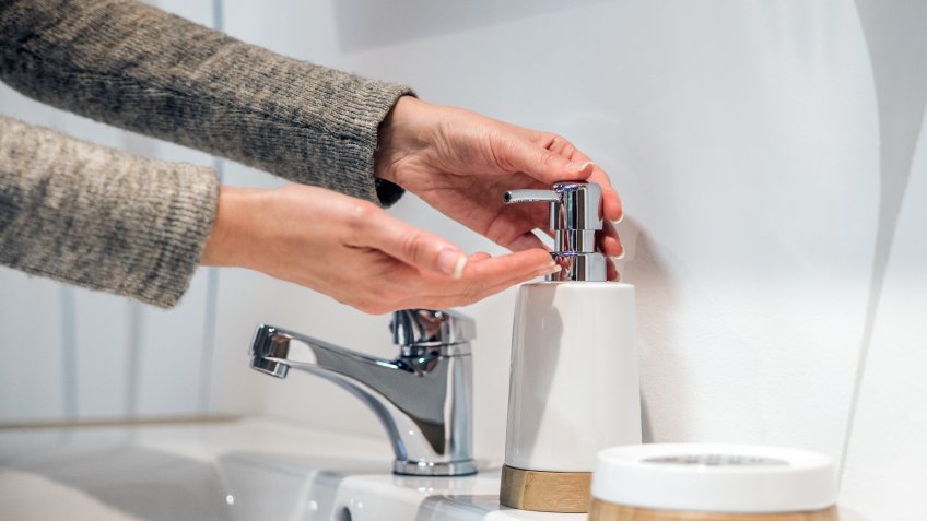 woman washing her hands with soap