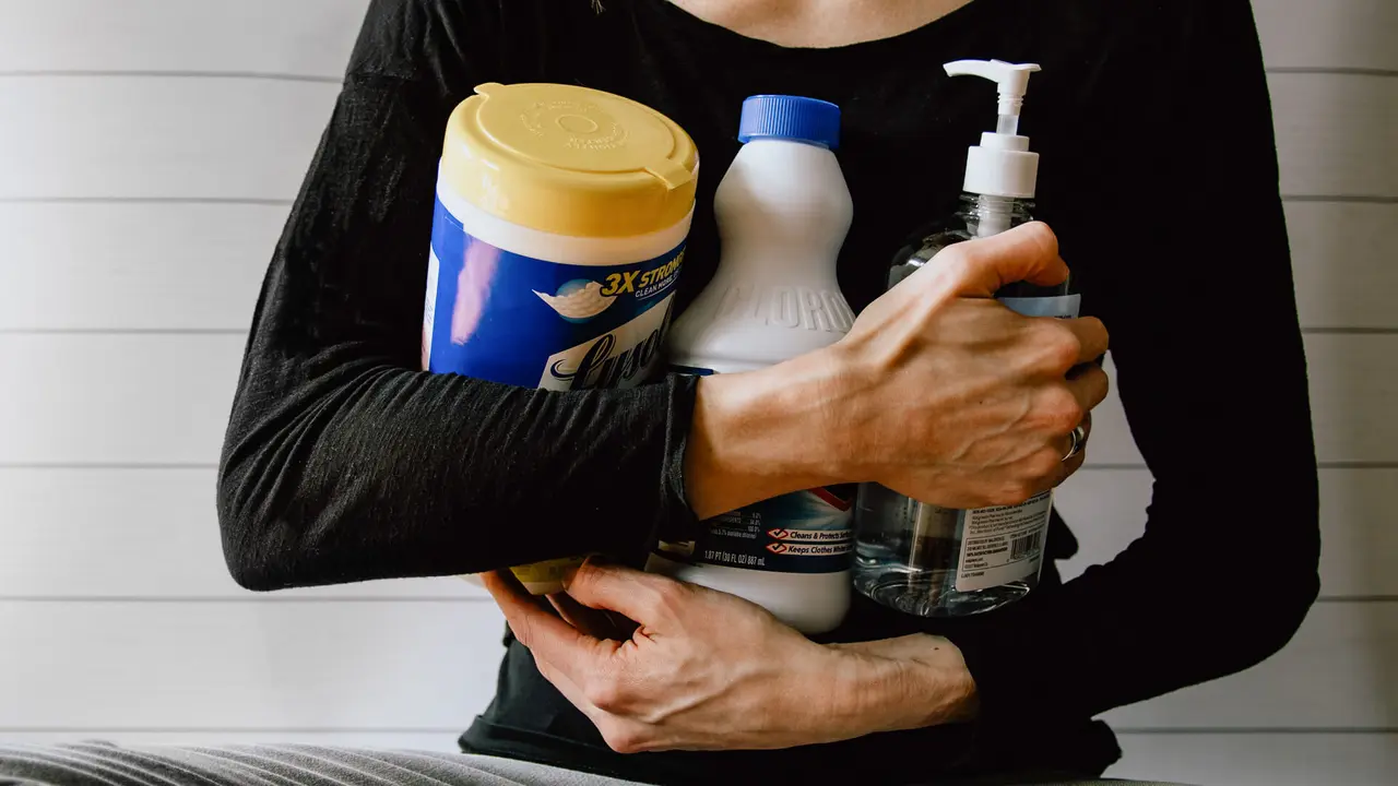 woman with disinfecting supplies
