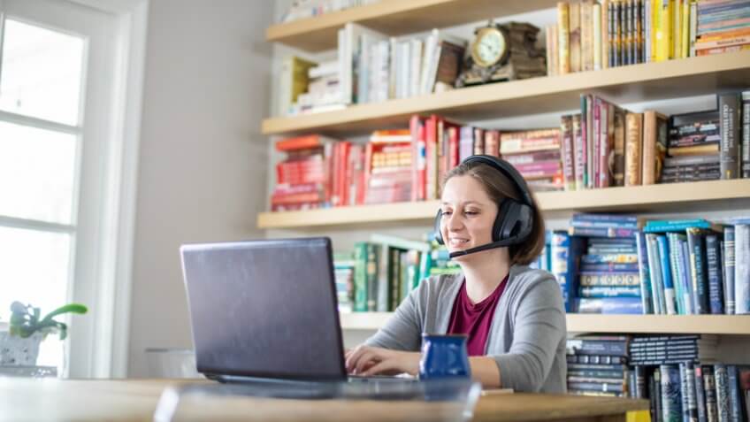 A beautiful young woman working from home.