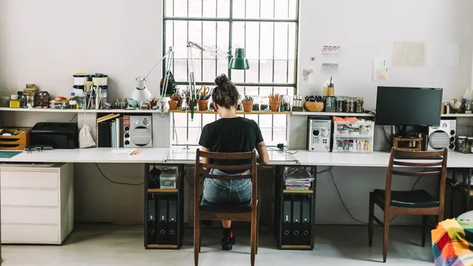 Rear view of artist working at desk.