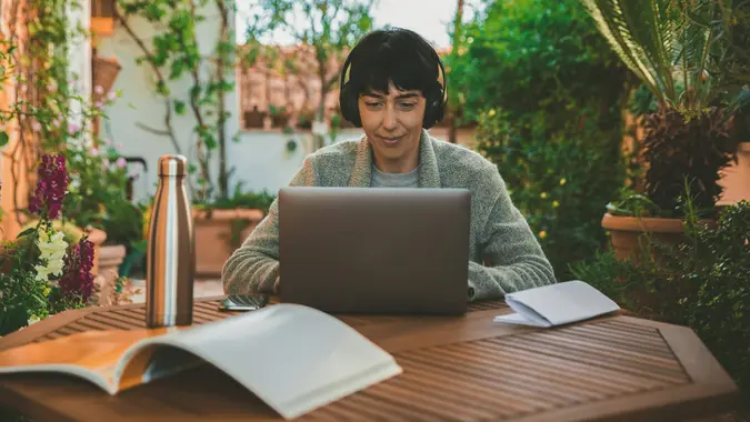 Woman at work from home patio during Covid-19 pandemic.