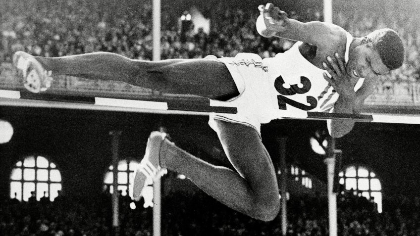 Charles Dumas, of the U.S., clears the bar during finals of the men's high jump competition who set a new Olympic record