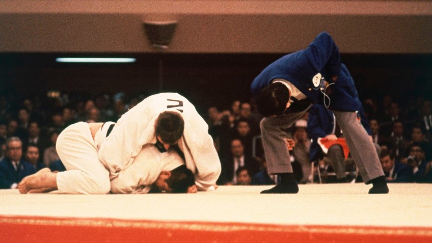 Seen here is Aston Geesink of the Netherlands and Aiko Kaminaga of Japan in heavyweight judo action at the 1964 Summer Olympics in Tokyo, Japan1964 Summer Olympics.