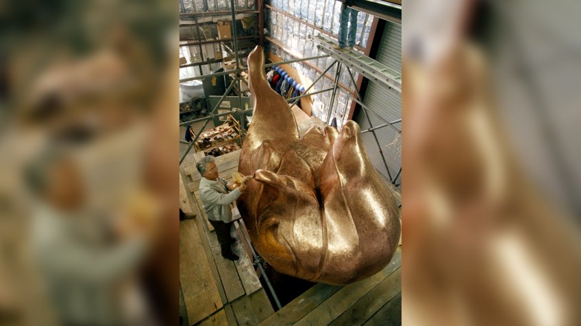 Robert Gohard, a member of the French team that is working on the restoration of the Statue of Liberty, puts finishing touches of gilding on the statue's new torch, 1985, in the same place where the original torch was constructedStatue Of Liberty Restorations 1985, France.