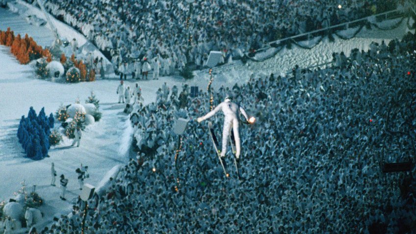 Associated Press Sports NORWAY APHS55401 OPENING CEREMONY Ski-jumper Stein Gruben soars over the crowd as he carries the Olympic Torch during Opening Ceremonies for the XVII Winter Olaympic Games in Lillechammer, Norway, Saturday, Feb.