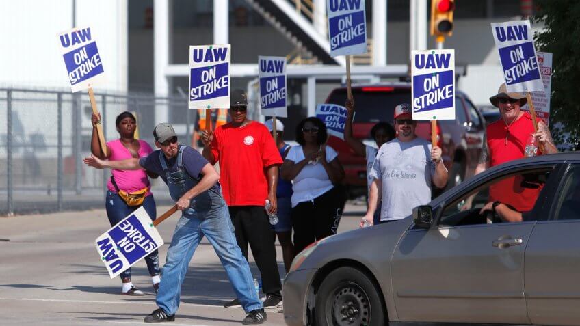 Mandatory Credit: Photo by LM Otero/AP/Shutterstock (10415460b)Gary Allison, left, waves while standing with other union members picketing outside the General Motors Plant in Arlington, Texas, .