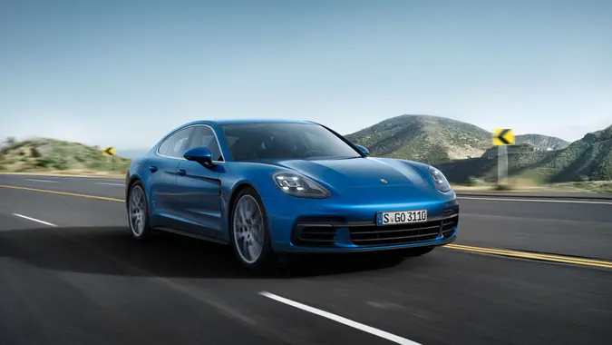A 2020 Porsche Panamera 4S driving on an open road for stock photo.