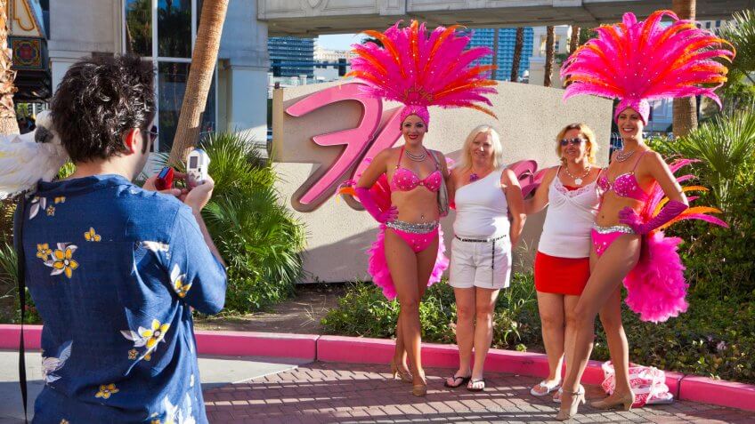 "Las Vegas, Nevada, USA - August 8, 2011: Showgirls working at the Flamingo casino, have their photo taken for tourists on along The Strip in Las Vegas.
