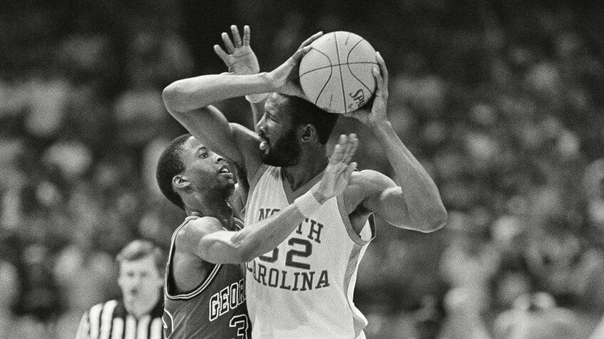 North Carolina forward James Worthy holds the ball away from Georgetown's Eric Smith during the NCAA championship game in New Orleans, .