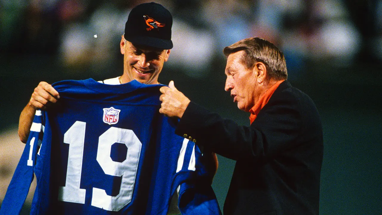 BALTIMORE, MD - SEPTEMBER 8: Former Baltimore Colt and football great Johnny Unitas presents one of his #19 jerseys to Cal Ripken Jr #8 of the Baltimore Orioles during an Major League baseball game September 8, 1995 at Oriole Park at Camden Yards Baltimore, Maryland.
