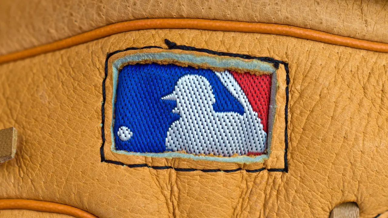 ZAGREB , CROATIA - AUGUST 19 , 2014 : MLB logo on baseball leather glove close up , product shot.