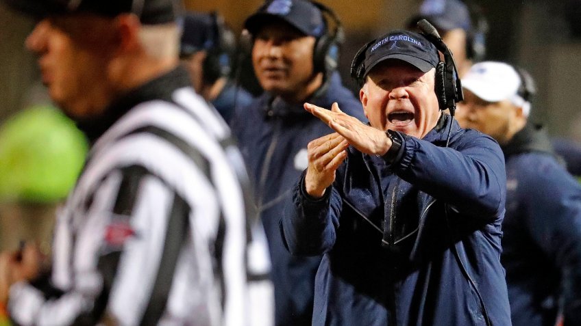 North Carolina head coach Mack Brown runs to take a timeout during the first half of an NCAA college football game against North Carolina State in Raleigh, N.
