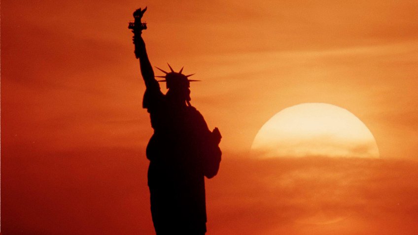 STATUE OF LIBERTY 1986 The Statue of Liberty is seen in silhouette as the sun sets in New York, May 1986Statue of Liberty 1986, NEW YORK, USA.