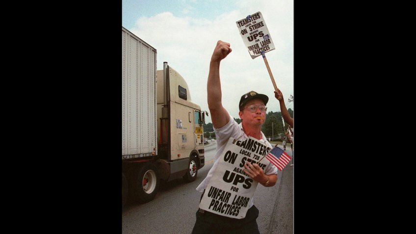 Mandatory Credit: Photo by John Bazemore/AP/Shutterstock (6530237a)MILLER Striking United Parcel Service driver David Miller reacts as a passing truck driver blows his vehicle's horn before a rally in front of the UPS distribution center in Tucker, Ga.