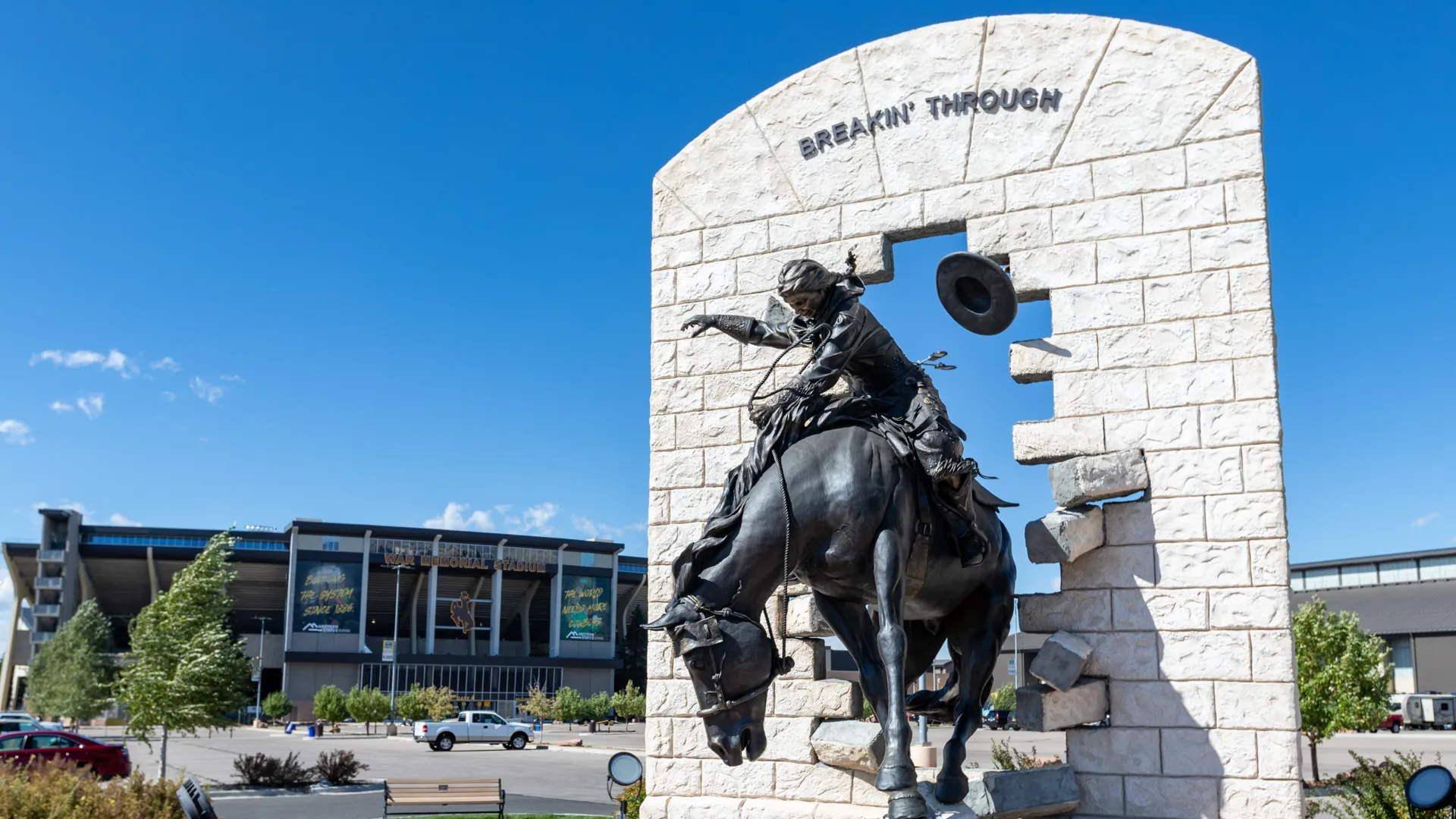 Laramie, WY, USA - September 28, 2019: "Breakin' Through" Bronze Statue at War Memorial Stadium at the University of Wyoming.