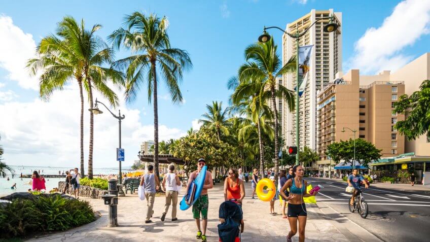 Waikiki, Hawaii, USA - January 5, 2014: People jogging, cycling and walking along Waikiki Beach.