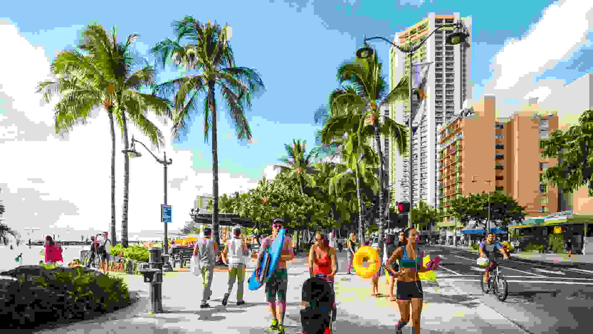 Waikiki, Hawaii, USA  - January 5, 2014: People jogging, cycling and walking along Waikiki Beach.