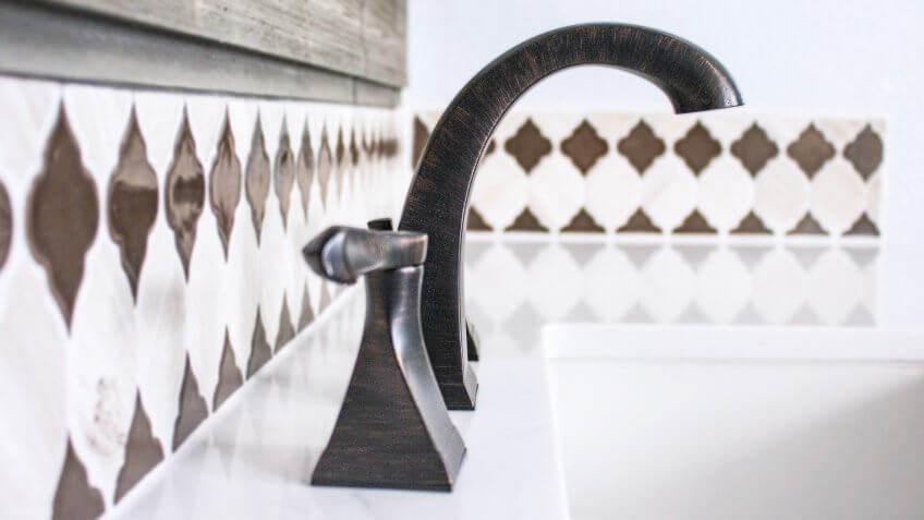 Bronze faucet in a newly remodeled bathroom.