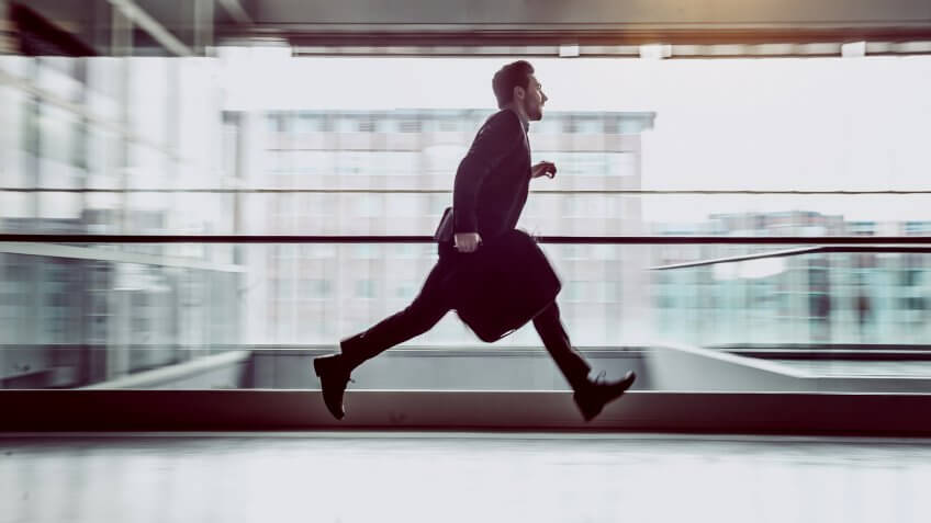 Businessman Running Across The Corridor.