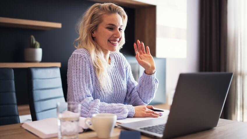 Beautiful businesswoman doing business video conference at home.